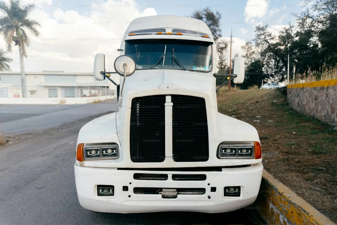 White semi-truck parked on a road