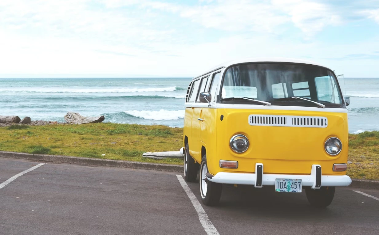 Yellow Volkswagen T2 van parked by the seaside